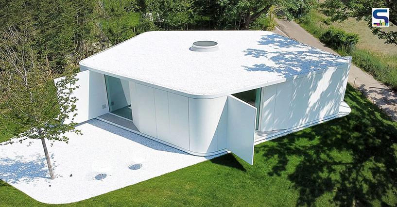 Designed by Milan studio JM Architecture, this holiday home in Italy is covered with glossy white concrete panels with a pentagonal plan.