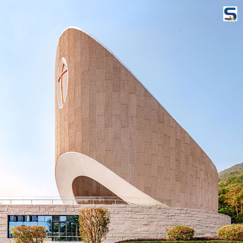 Inspired by biblical archetypes, the church resembles an ark resting on a rock, located at a mountains base amidst a forest with views of the town.