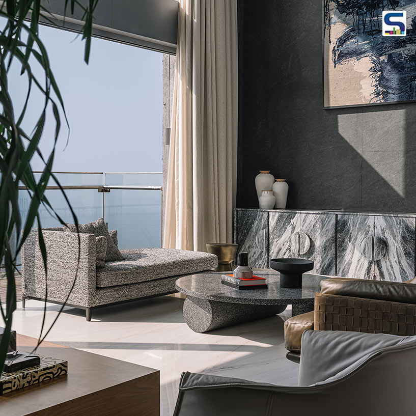 Dramatic Double-Height Living Room with Graphite Stone Walls in Apartment 21 by Jason Wadhwani | Mumbai